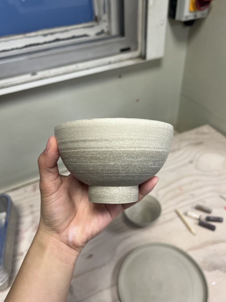 Trimmed stoneware bowl held in hand
