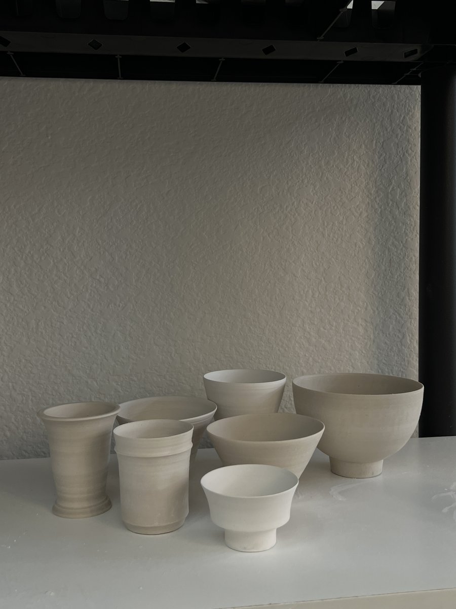 Bisqueware bowls and cups on a shelf